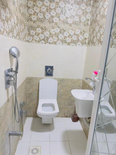 a bathroom with a toilet and a sink at مضيف الزهراء in Karbala