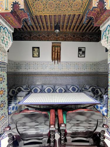 a room with a table in a room with a ceiling at Riad Green House in Fez
