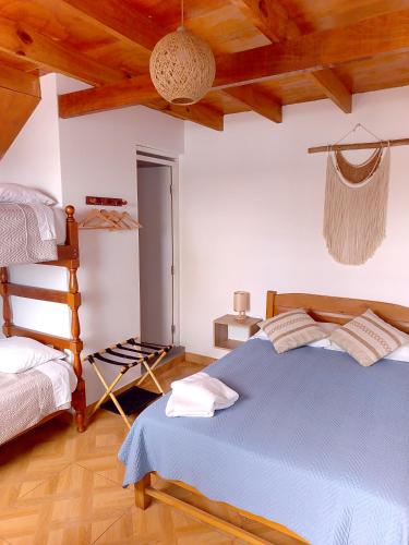 a bedroom with a blue bed and a ladder at VIVEMAR PUNTA HERMOSA - Beach House Lima - Perú in Punta Hermosa
