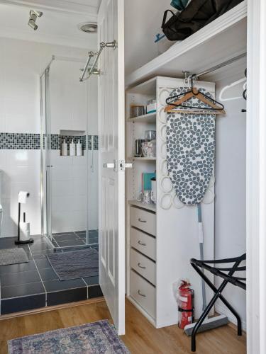 a bathroom with a shower and a walk in shower at King bed studio seperate entry sauna pool garden view in Terranora