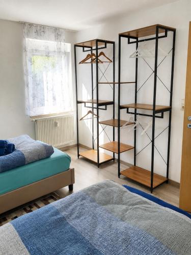 a room with two beds and a book shelf at Ferienwohnung Varli in Tuttlingen