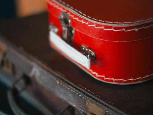 a red suitcase sitting on top of a table at Vienna House Easy by Wyndham Berlin Prenzlauer Berg in Berlin