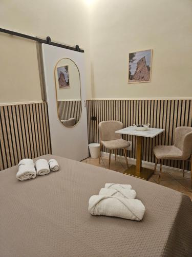 a room with a bed and a table and chairs at Corte26 in Nocera Inferiore