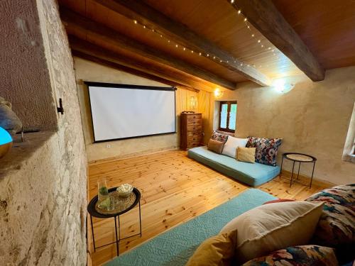a living room with a couch and a screen at Villa Violica, Karnevali in Žminj