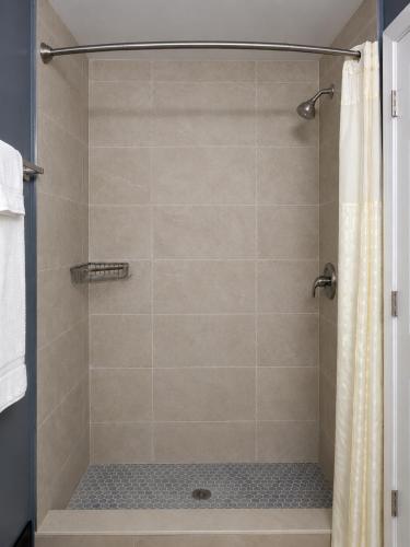 a bathroom with a shower with a shower curtain at Sunwestern Suites in Douglasville