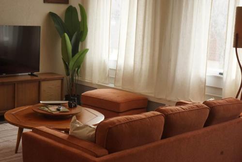 a living room with a couch and a table at The Grey Cannon Guest House in Saint Cloud