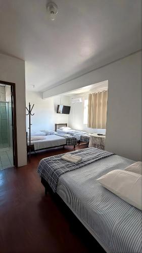 a room with two beds in a room at Hotel Iung in Alfredo Wagner