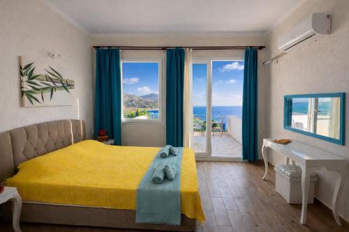 a bedroom with a bed and a view of the ocean at Goknar Knidos Nature Hotel and Farm in Datca