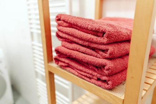 a pile of red towels on a shelf at City Center Studio in Graz