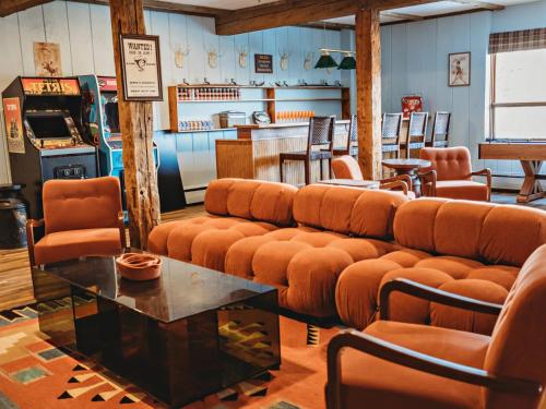 a waiting room with a couch and a soda machine at Hideaway Inn Mt Snow in Dover
