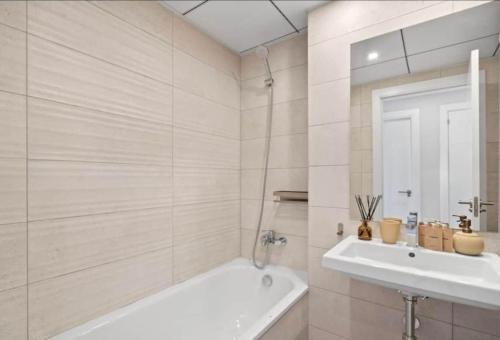 a white bathroom with a tub and a sink at Palm Forest Oasis in Mijas Costa