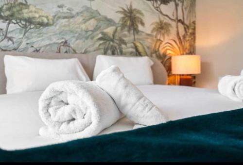 a bed with white towels on top of it at Palm Forest Oasis in Mijas Costa