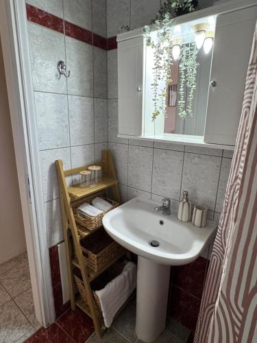 a bathroom with a sink and a mirror at Rocky Stays - Argostoli Central Studio in Argostoli