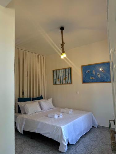 a bedroom with a bed with two towels on it at Rocky Stays - Argostoli Central Studio in Argostoli