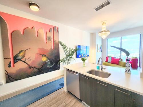 a kitchen with a sink and a painting on the wall at Marina Miami Penthouse- Downtown-Brickell 2BD-2BA in Miami
