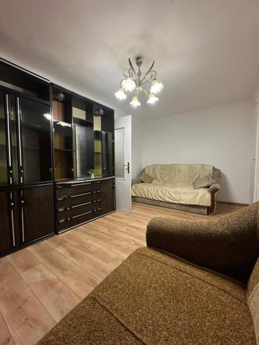 a living room with a bed and a couch at Horodotska Street in Lviv