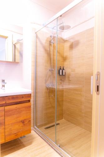 a shower with a glass door in a bathroom at Sunmed Lodge in Oludeniz