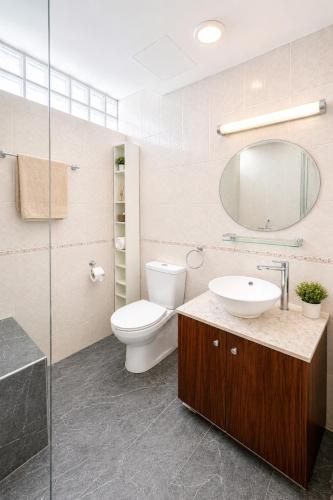 a bathroom with a toilet and a sink and a mirror at Best Seaview in Larnaca - 2 BDR Apt - 2 Min Walk to Beach in Larnaca