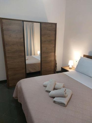 a bedroom with a bed with two towels on it at KATHRIN APPARTS in Alepou