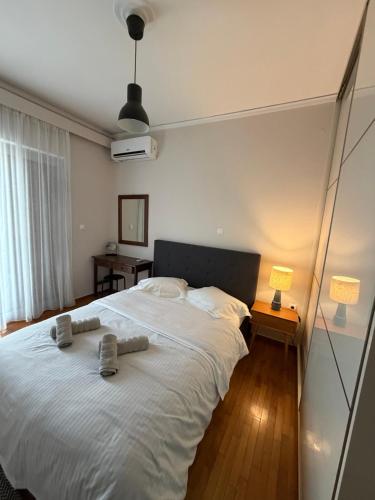 a bedroom with a large white bed with towels on it at City View Apartment in Mytilene
