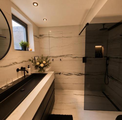 a bathroom with a sink and a shower at Penthouse city & cathedral View for 4 in Antwerp