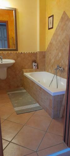 a bathroom with a bath tub and a sink at VelaLatina in Stintino