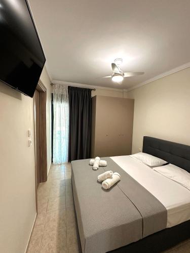 a bedroom with a bed with towels on it at DIARA APARTMENT in Nea Irakleia