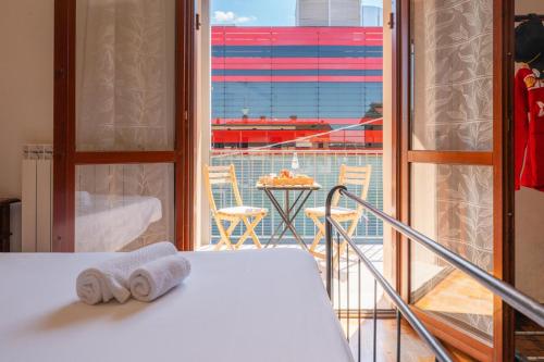 a room with a bed and a balcony with a view at Maranello Suite in Maranello