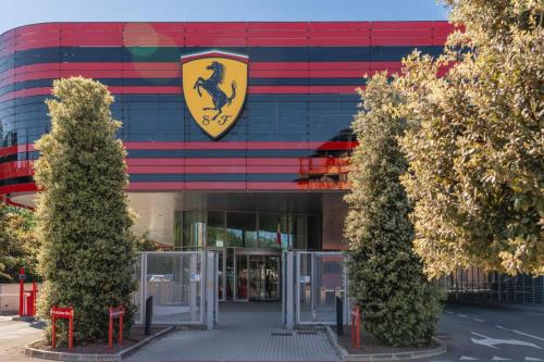 a building with a crest on the side of it at Maranello Suite in Maranello