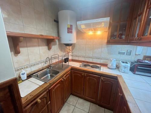 a kitchen with a sink and a counter top at Refugio del volcán in Pucón