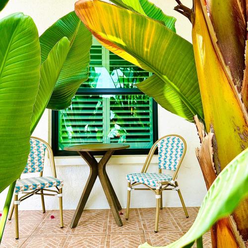 a table and two chairs in front of a window at Acqua Atelier by Vanderbilt Beach in Naples