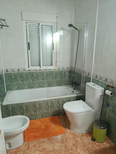 a bathroom with a tub and a toilet and a sink at Veronica Villa in Partaloa