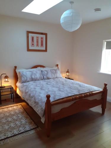 a bedroom with a bed with a wooden frame at The Lodge in Galway