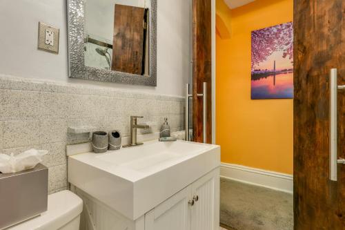 a bathroom with a white sink and a toilet at Historic Georgetown Townhome: Walkable Location! in Washington, D.C.