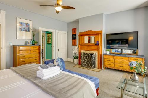 a living room with a bed and a flat screen tv at Historic Georgetown Townhome: Walkable Location! in Washington, D.C.