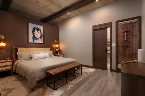 a bedroom with a large bed with a bench in it at Pulaski Point Properties in Chicago