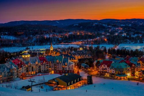 an aerial view of a town in the snow at night at Tremblant Ski Condo, Fast WIFI & Free parking in Mont-Tremblant