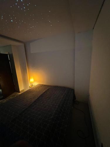 a small room with a bed with a light on it at Imperial Rodrigues Valley in Juquitiba