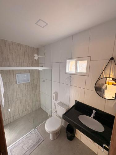 a bathroom with a toilet and a sink at Pousada O Sol De Maragogi in Maragogi