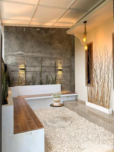 a lobby with a bench and a table at Tafufu Villa Tumpak Sewu in Sumberbopong