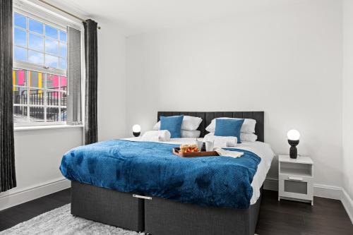 a bedroom with a large bed with a blue blanket at Cheshire Dimond one bedroom flat in Warrington in Warrington