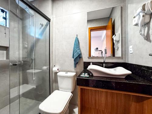 a bathroom with a shower and a toilet and a sink at Loft Novo e Completo no Centro • 4 Pessoas in Brusque
