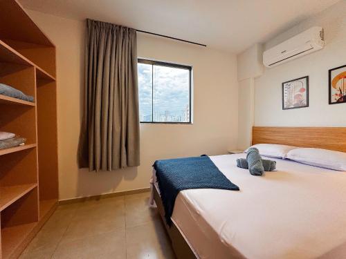a bedroom with a large bed and a window at Loft Novo e Completo no Centro • 4 Pessoas in Brusque