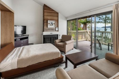 a bedroom with a bed and a living room at Rosario Resort in Eastsound