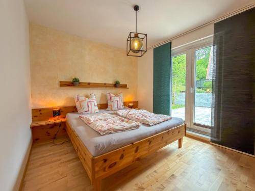a bedroom with a bed and a large window at Apartment Franz in Sattendorf