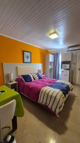 a bedroom with a large bed in a room at Cabañas Amalar in Malargüe