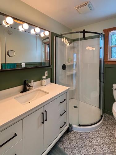 a bathroom with a sink and a shower at Sunrise Place Bed & Breakfast in DʼEscousse