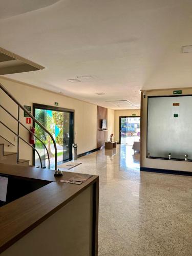 an empty lobby with a large screen in a building at Imperial Hotel in Santa Bárbara