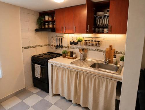 a kitchen with a sink and a stove at Apartamento FullLife in Zipaquirá