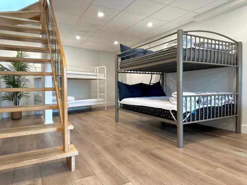 a room with two bunk beds and a staircase at Lakehouse Paradise in Val des Monts